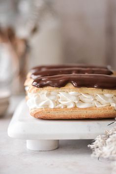 a chocolate covered pastry sitting on top of a white plate