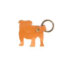 an orange leather keychain with a pug on it