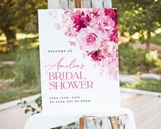 a welcome sign for a bridal shower is displayed on an easel in front of a wooden deck