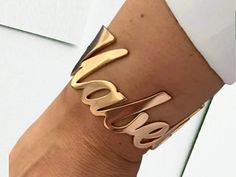 ✨ Express Yourself with this stunning Personalized Name Women's Bangle, crafted from high-quality stainless steel. This chic bracelet is perfect for adding a touch of individuality to your style, whether you're dressing up for a special occasion or adding flair to your everyday look. Available in gold, silver, rose gold, and black, this bangle is designed to complement any outfit. 💖 Features: Material: Durable Stainless Steel with high-quality plating Color Options: Gold, Silver, Rose Gold, Bla Elegant Metal Bracelet With Custom Name, Personalized Rose Gold Bracelets For Party, Elegant Custom Name Metal Bracelet, Personalized Rose Gold Bracelet For Party, Modern Rose Gold Cuff Bracelet For Party, Modern Rose Gold Party Cuff Bracelet, Rose Gold Metal Cuff Bracelet As Gift, Womens Bangles, Punk Inspiration