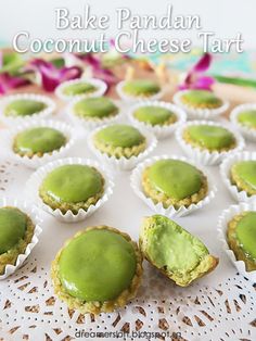 small cupcakes with green icing sitting on a doily