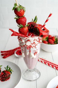 a strawberry milkshake with strawberries and sprinkles on the top