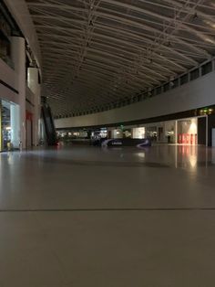 an empty parking garage with cars parked in it