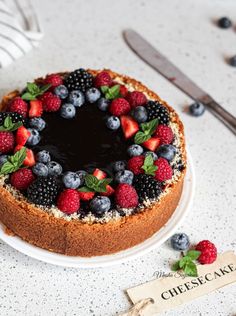 a cake with berries, blueberries and raspberries on it