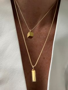 The clean lines and balanced proportions of the rectangle symbolize order, structure, and organization. Like the foundation of a well-designed space, the rectangle represents stability and harmony in both style and life.As you wear the 14K Gold Rectangle Necklace, let its symbolism inspire you. Embrace the qualities of order and balance that the rectangle represents, empowering you to approach life with clarity and purpose. Let it serve as a reminder to stay grounded and focused on your goals, e Gold Cube, Gold Ball Chain, Gold Gemstone Necklace, Yellow Pendant, Rectangle Necklace, Cube Necklace, Stay Grounded, Ball Chain Necklace, Ball Chain