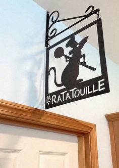 a sign hanging from the side of a door that says bratatoulie on it