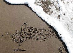 an image of music notes drawn in the sand