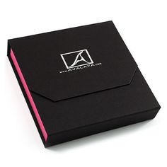 a black box with a pink stripe on the side and a logo on the front