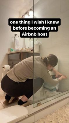 a woman squatting down in front of a toilet