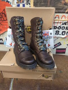 These 9 hole Dr Martens boots are a style that's no longer in production. They were part of the Triumph range, just a lower version. The boot is finished in a nice brown waxy leather. It has a stitched toe cap and camo laces matching it's interior. The boot can be folded to show it off . These are a UK size 3, European 36,ladies USA 5 Brown Lace-up Combat Boots With Rubber Sole, Brown High Ankle Combat Boots With Reinforced Toe, Brown Reinforced Toe Ankle Combat Boots, Brown Ankle Combat Boots With Reinforced Toe, Brown Steel Toe Rugged Combat Boots, Brown Rugged Combat Boots With Steel Toe, Rugged Brown Combat Boots With Steel Toe, Brown High Ankle Boots With Laces, Brown Lace-up Moto Boots With Steel Toe