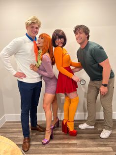 four people dressed up in costumes posing for the camera