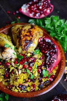 chicken and rice with pomegranates in a wooden bowl