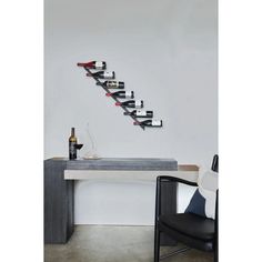 there is a wine rack on the wall next to a desk with a chair and bottle