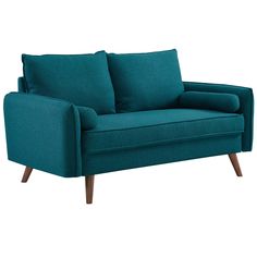 a teal couch with two pillows on top of the armrests and legs