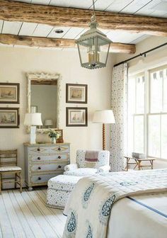 a bedroom with a bed, dresser and mirror in it's centerpieces