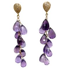 Description Elegant statement Amethyst briolette dangle earrings, hand wire wrapped in 14 carat yellow gold, suspended from a pave diamond stud. Item # E3294 Materials and Weight Amethyst, 99 carats, faceted briolette shape Pave diamonds Vermeil studs with gold posts and jumbo backs 14k yellow gold chain Dimensions Length 3 inches Made in Newport Beach, California. USA Luxury Exquisite Briolette Earrings, Luxury Briolette Amethyst Jewelry, Luxury Purple Briolette Jewelry, Purple Briolette Amethyst Jewelry, Luxury Purple Briolette Earrings, Yellow Gold Chain, Newport Beach, Newport, Diamond Studs