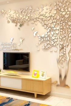 a living room with a large tree on the wall and butterflies flying around it,