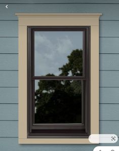 an open window on the side of a blue house with trees in the background and clouds overhead