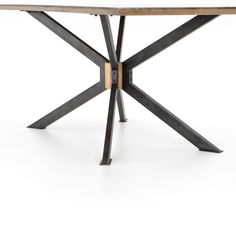 a wooden table with metal legs and an iron frame on the top, against a white background