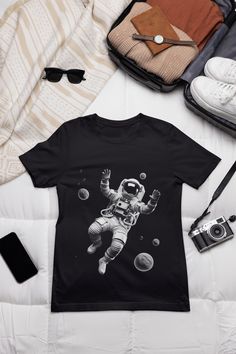 astronaut T-shirt, spaceman shirts, spacewoman shirt, cosmonaut tees, family astronaut tees, funny astronaut shirt HI! Welcome to my store, I'm delighted to see you here. My store's main goal is to make you happy. Please contact me if you have any questions or want to get a custom-made design. I'm sure you'll love my designs. If you liked the design but didn't like the shirt color we have, please contact me. I will do my best to make you satisfied. ABOUT THE SHIRTS: This classic unisex jersey short sleeve tee fits like a well-loved favorite. Soft cotton and quality print make users fall in love with it over and over again. These t-shirts have-ribbed knit collars to bolster shaping. The shoulders are tapered for a better fit over time. Dual side seams hold the garment's shape for longer. Ma Funny Astronaut, Astronaut Graphic, You Happy, Shirt Color, Wedding Shop, Gift Registry, See You, Print Making, Print Quality