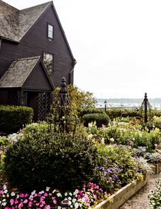 a house with lots of flowers in front of it