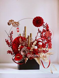 a vase filled with lots of red flowers