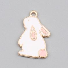 "Adorable little white enameled bunny Approx:22mm x14mm( 7/8\" x 4/8\") Hole size: 1.7mm( 1/8\") Thickness: 1.5mm Quantity: pick at checkout Metal alloy with gold toned backs Have questions? or are you looking for something similar that you want me to carry? please let me know. Have questions? or are you looking for something similar that you want me to carry? please let me know. HOW PACKAGES ARE SHIPPED AND UPGRADED SHIPPING OPTIONS: ** PACKAGES SHIPPED WITHIN CANADA** Mail in Canada is shipped White Enamel Pendant Charm Necklaces, White Enamel Charm Necklaces, Cute White Charms For Gifts, Rabbit Charm, Rabbit Pendant, Bunny Face, Metal Charms, Pink Bunny, Cute Charms