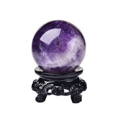 an amethyst ball sitting on top of a small black stand with a white background