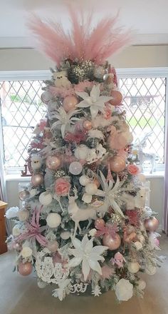 a decorated christmas tree with pink and white ornaments