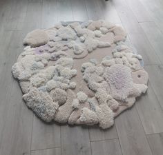 a white rug on the floor with various shapes and sizes