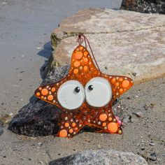 an orange and white starfish with googly eyes