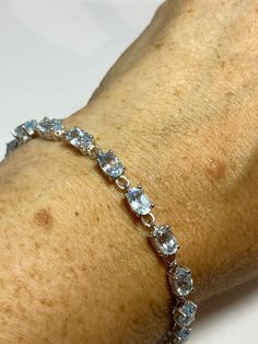 Vintage Blue Aquamarine 925 Sterling Silver Tennis Bracelet https://www.etsy.com/listing/1263415020/vintage-blue-aquamarine-925-sterling?utm_source=crowdfire&utm_medium=api&utm_campaign=api Sterling Silver Gemstone Tennis Bracelet, Luxury Silver Bracelet With Blue Topaz, Luxury Silver Bracelets With Blue Topaz, Sapphire Sterling Silver Bracelet, Wedding Bracelets With Blue Topaz Gemstones, Blue Topaz Gemstone Bracelets For Wedding, Elegant White Gold Bracelet With Blue Topaz, Elegant Adjustable Blue Topaz Bracelets, Elegant Light Blue Faceted Jewelry