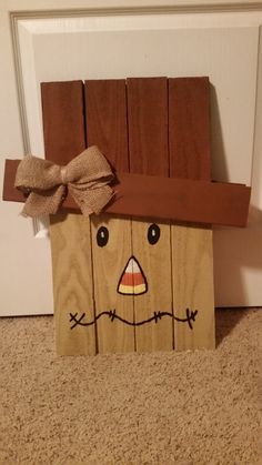 a paper bag with a scarecrow face on it sitting in front of a door