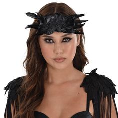 Add just enough drama to your dark goddess or angel look with this elegant headpiece. The headband fits front to back across your forehead. It's topped with a crown of black feathers fronted by a filigree bow with felt flowers and a black gem. The elastic strap keeps it snug as you haunt the night. pbBlack Dark Angel Feather Headpiece product details:-b-p ul li10.5in wide x 5in tall-li liFelt-covered elastic headband-li liPolyester feathers and metal-li liDoes not include top-li liOne size fits most teens and adults-li -ul Adjustable Black Feather Headpiece, Adjustable Black Feathered Headpiece, Black Headband For Costume Party, Black Gothic Headpiece For Party, Black Festival Headband Hair Accessories, Black Festival Hair Accessories Headband, Black Headband For Festival, Black Headband Hair Accessories For Festival, Elegant Black Festival Headpieces