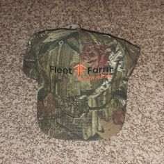 a camo hat that says fleet farm on it