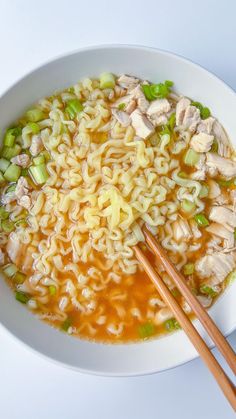 a bowl of ramen with chopsticks on the side