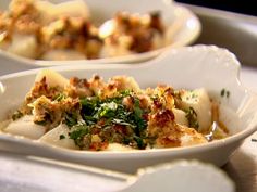 two white plates filled with food on top of a table