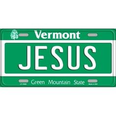 a green license plate with the word jesus in white lettering on it and an image of a