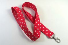 This cute lanyard has beautiful heart polka dots on red. It is perfect for any occasion. You can leave me a convoy if you need a different size. You can have a wardrobe of lanyard to match your outfit. This lanyard is made of soft 100% cotton fabric to give a comfortable feel around your neck. This lanyard is easy to take care. You can spot clean and throw in a washer and hang dry. If you want you can iron and it is ready to use. These lanyards are perfect if you have metal allergy. Each of thes Red Lanyards With Key Leash For Gifts, Cheap Novelty Heart-shaped Badge Holders, Multicolor Lanyards With Lobster Clasp For Everyday Use, Red Lanyards With Key Leash, Casual Adjustable Multicolor Lanyards, Cute Lanyard, Dot Heart, Cute Lanyards, Patriotic Fabric