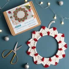 a crochet christmas wreath and scissors on a table