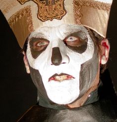 a man wearing a white and black face paint