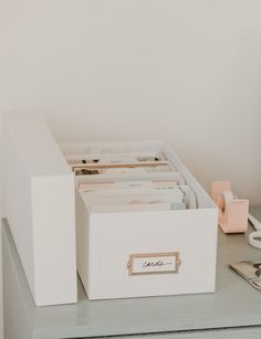 a desk with a file cabinet and phone on it