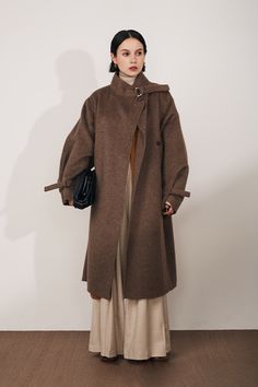 Luxe Stand Collar Coat: Winter's Must-Have Chic Crafted from premium first-cut Merino wool blended with a hint of rabbit hair for softness, this coat redefines winter luxury. Its classic trench sleeve tabs for adjustable length, complementing its loose A-line silhouette and dropped shoulder sleeves. Perfect for layerin Classic Brown Fur Coat For Work, Fall Wool Fur Coat With Faux Fur Lining, Wool Fur Coat For Cold Weather In Fall, Classic Fur Coat For Work In Fall, Brown Long Fur Coat For Work, Fall Wool Fur Coat For Workwear, Lambswool Outerwear With Faux Fur Lining For Fall, Fall Wool Outerwear With Faux Fur Lining, Classic Lambswool Outerwear For Winter