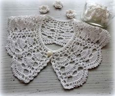 a crocheted doily is laying on a table next to some cotton balls