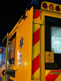 an ambulance is parked at night with its lights on