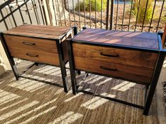 two wooden drawers sitting next to each other on a balcony