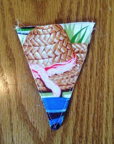 a piece of fabric with an image of a pineapple on it sitting on a wooden table