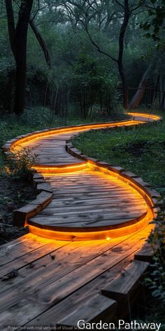 a wooden path with lights on it in the woods