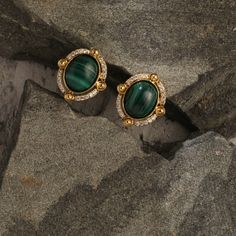 Description Inspired by the beautifully patterned Malachite gemstone, the earliest ore of copper, Tamra is eccentric, contemporary, and distinctively classy. Handcrafted on 925 hallmark silver and gold finish. This collection is curated for everyday luxury. These stud earrings feature an oval malachite charm at the center. The frame of the charm is encrusted with a line of CZ stone to add extra sparkle. Striking earrings to style with Paksha's unmatched delicate jewelry. Product Information Mate Temple Jewellery Earrings, Handmade Embroidery Designs, Everyday Luxury, Jewellery Earrings, Gold Earrings Designs, Handmade Embroidery, Silver Stud Earrings, Delicate Jewelry, Temple Jewellery