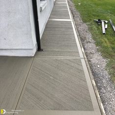 a cat is sitting on the side of a building